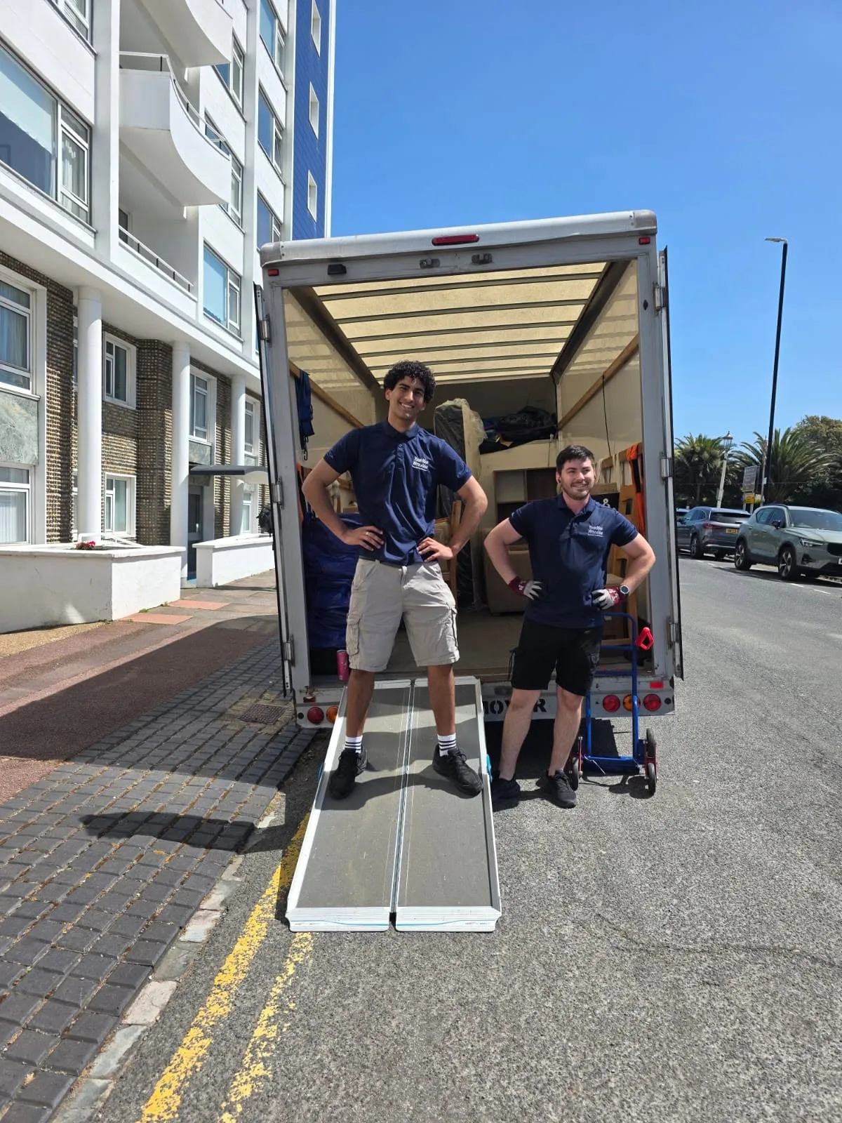 Your Man With A Van movers loading a removal van on a Brighton and Hove seafront street