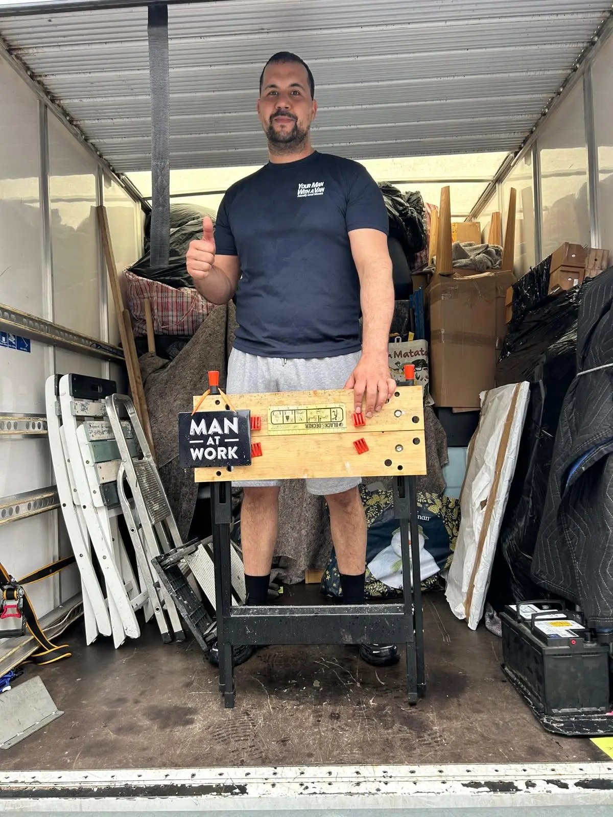 Your Man With A Van mover in the back of a loaded removal van, ready to get to work